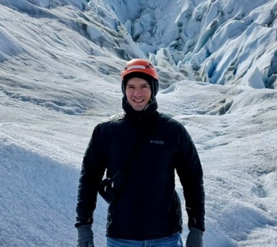 Javier Piedra standing in front of a glacier